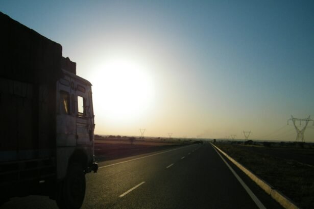 gray truck on asphalt road during sunset